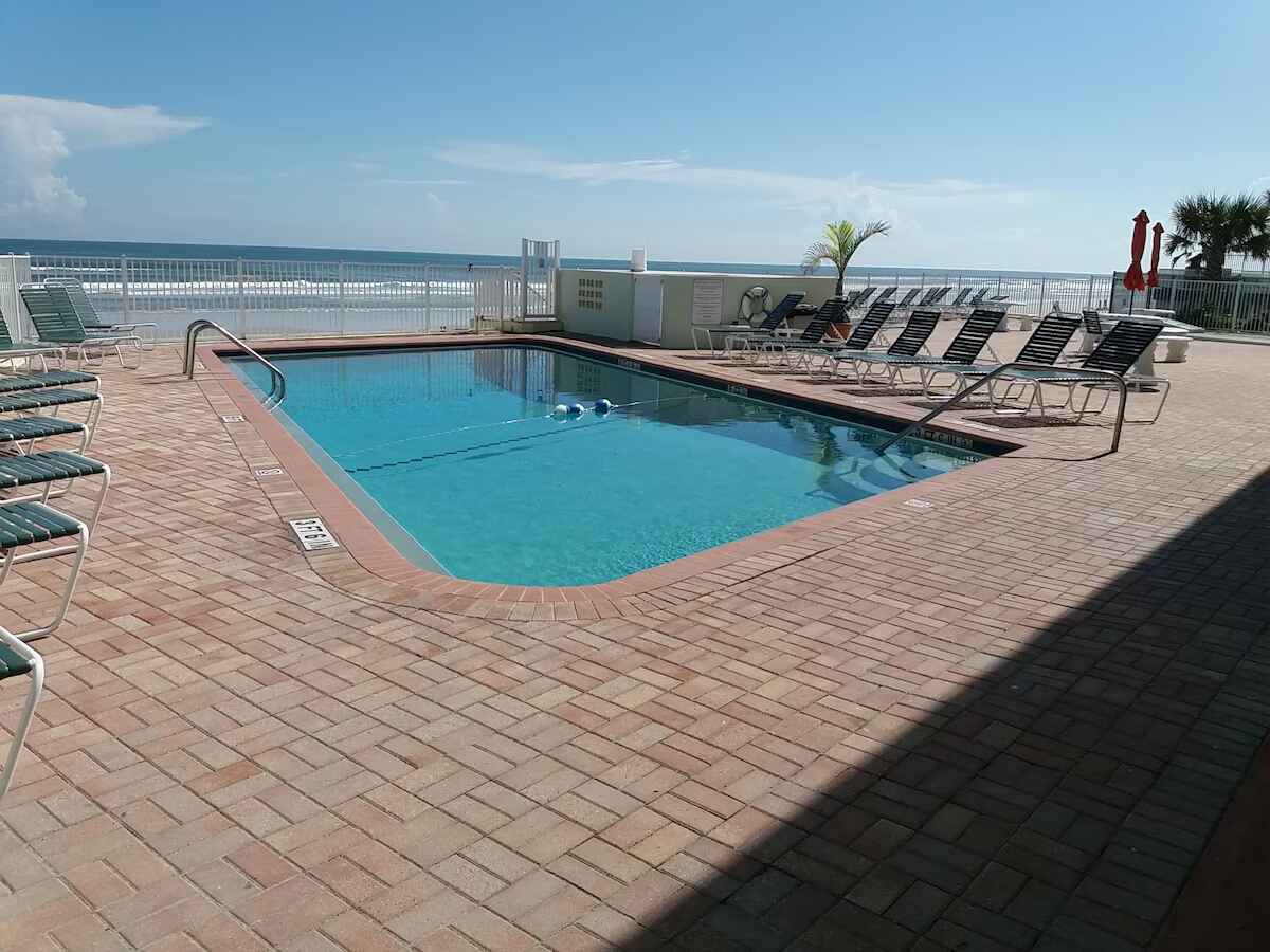 Pool area with loungers and umbrellas